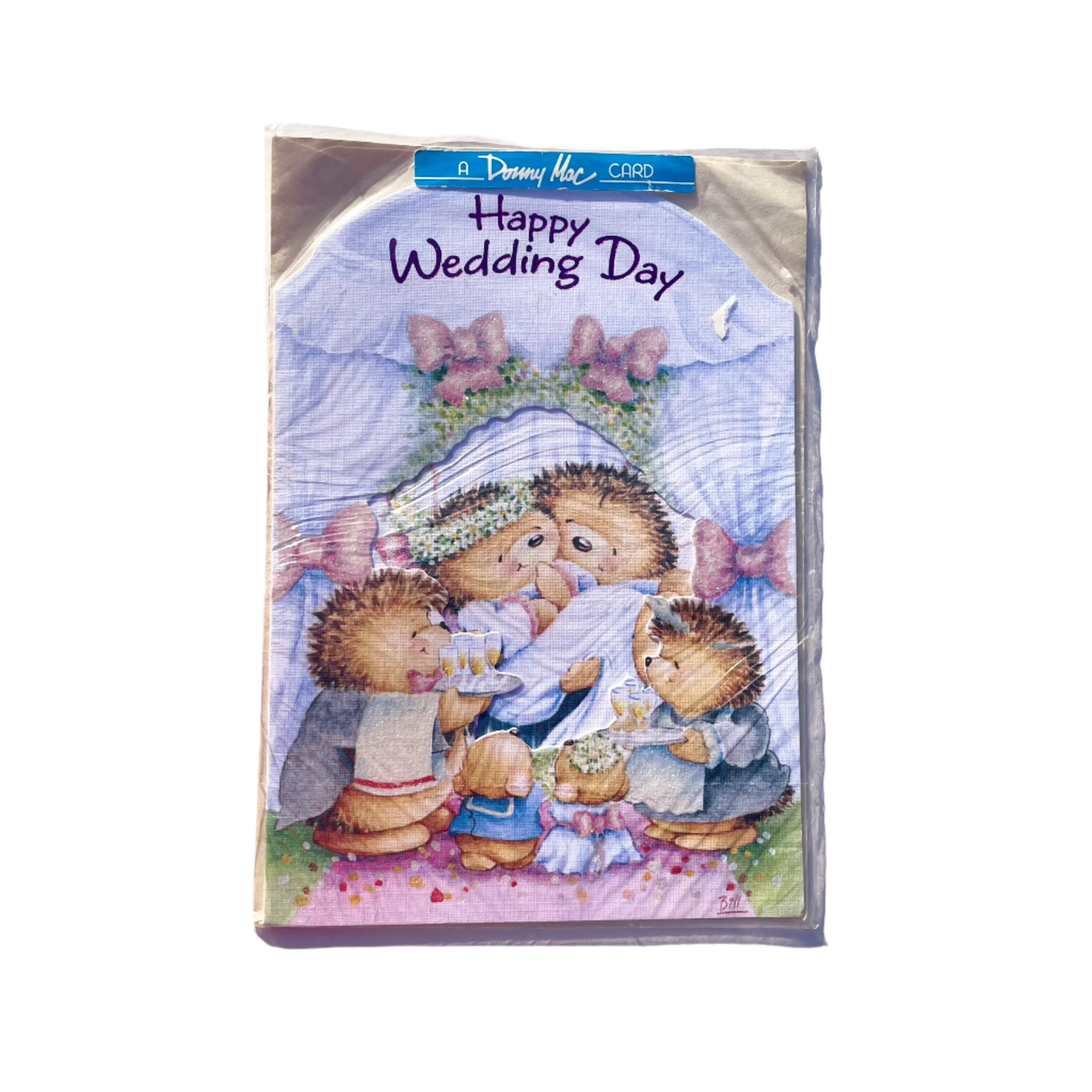 A greeting card with an illustration of a hedgehog couple and friends with 'Happy Wedding Day' text on the front.