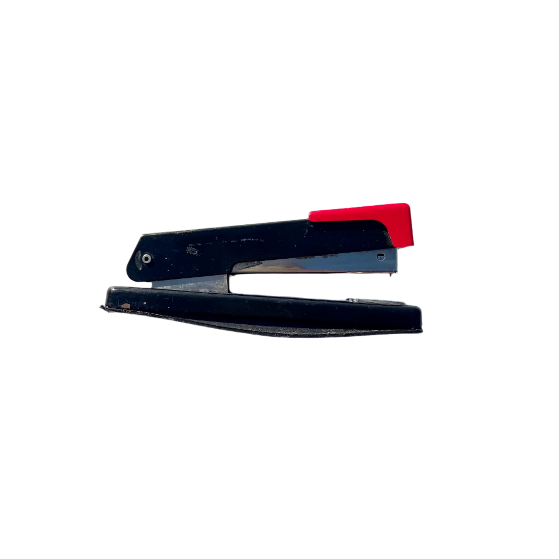 A vintage black and red stapler with visible signs of wear and rust.