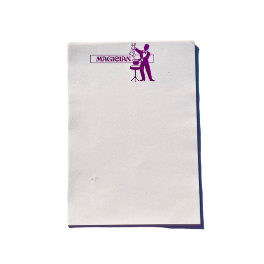 Sheets of white writing paper with a purple print of a magician at the top, titled 'MAGICIAN' beside the illustration.