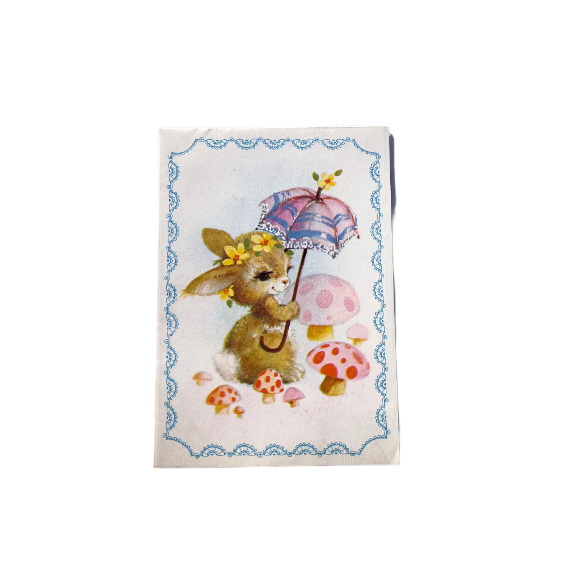 A vintage paper card depicting a stylized rabbit character with a floral crown and a parasol, surrounded by mushrooms and decorative elements.