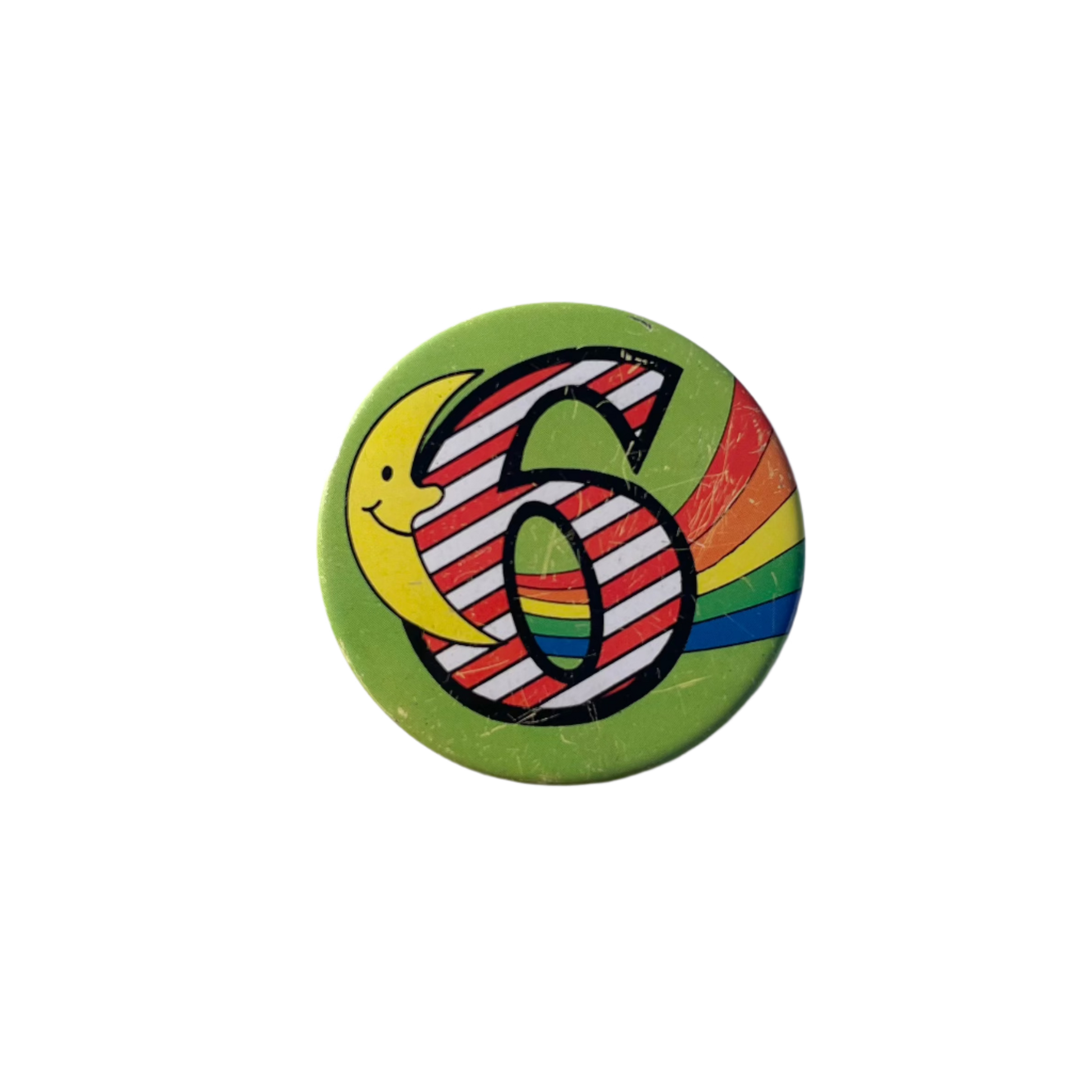 A colorful birthday badge with the number 6 on it, featuring a semi sun and rainbow design. 